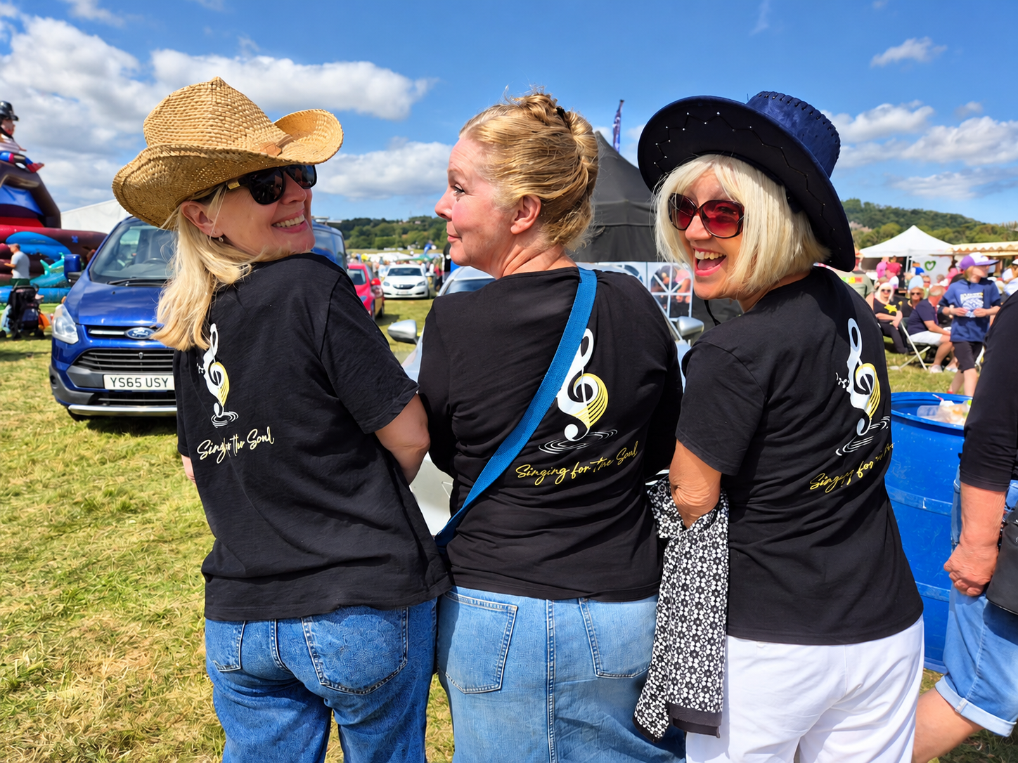 Three Singing for the Soul friends enjoying a sunny festival