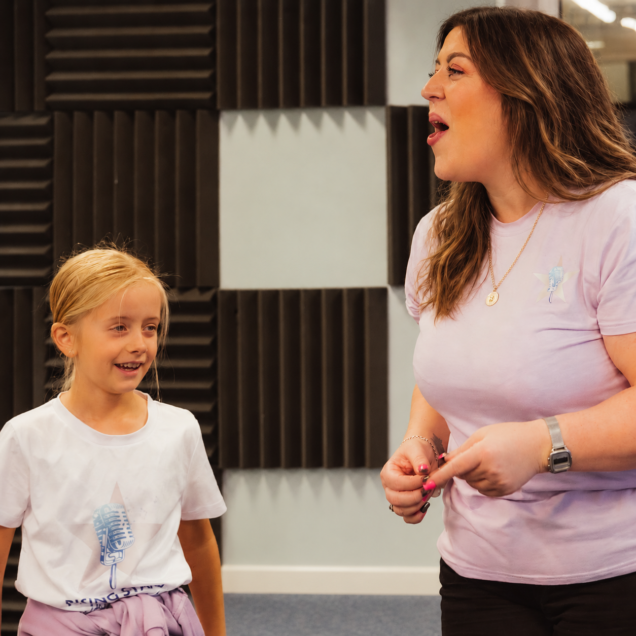 Ella helping a young Rising Stars singer during a session