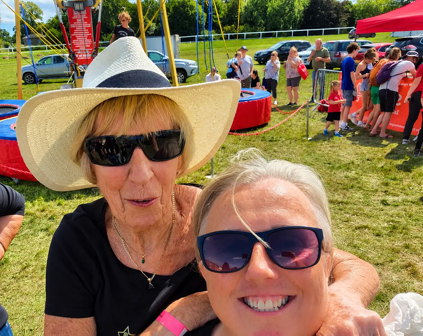 Two choir friends sharing a selfie at a park event