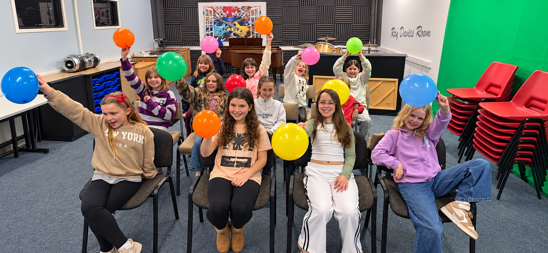 Rising Stars children with balloons in a music room