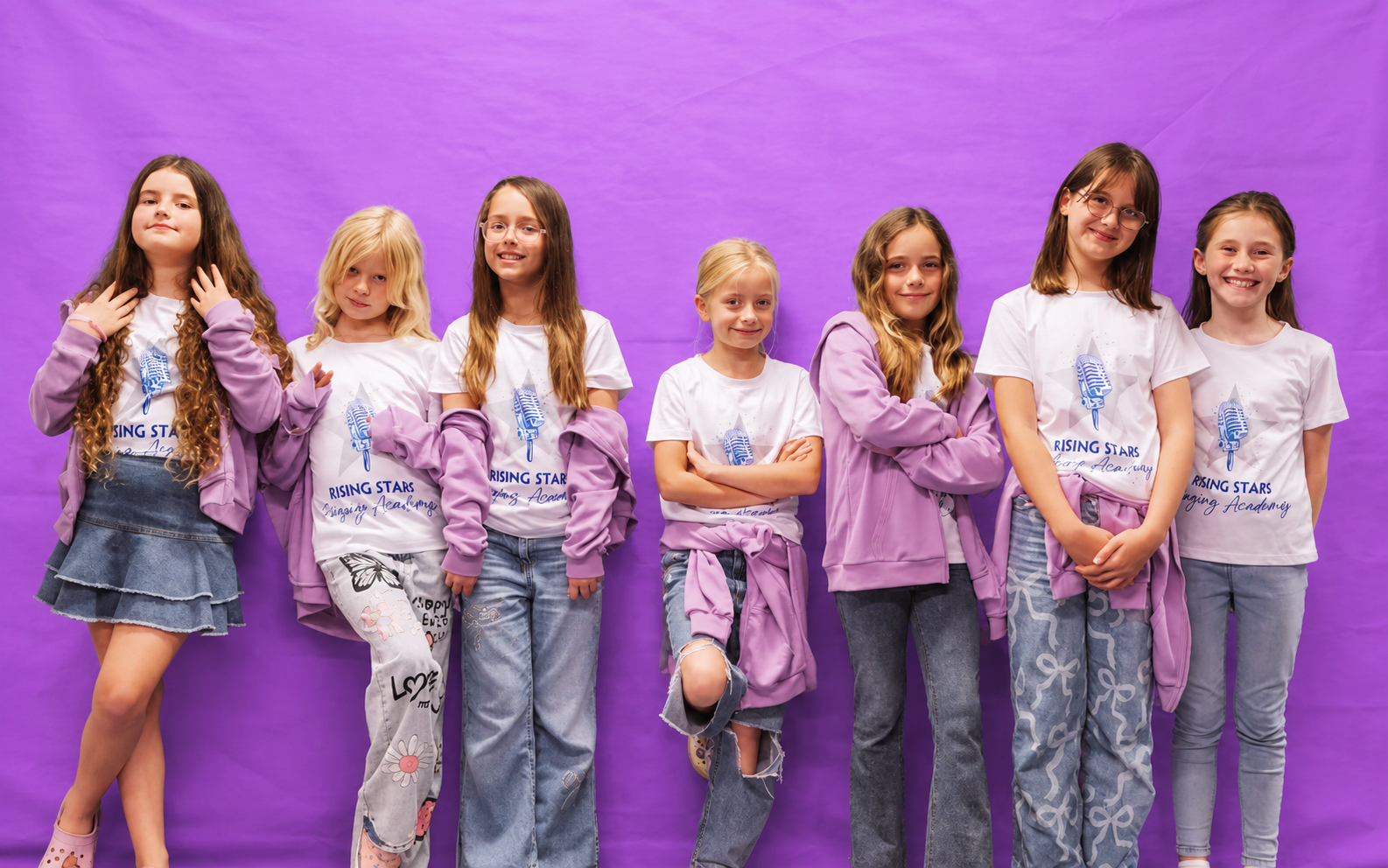 Rising Stars children together in front of the purple backdrop